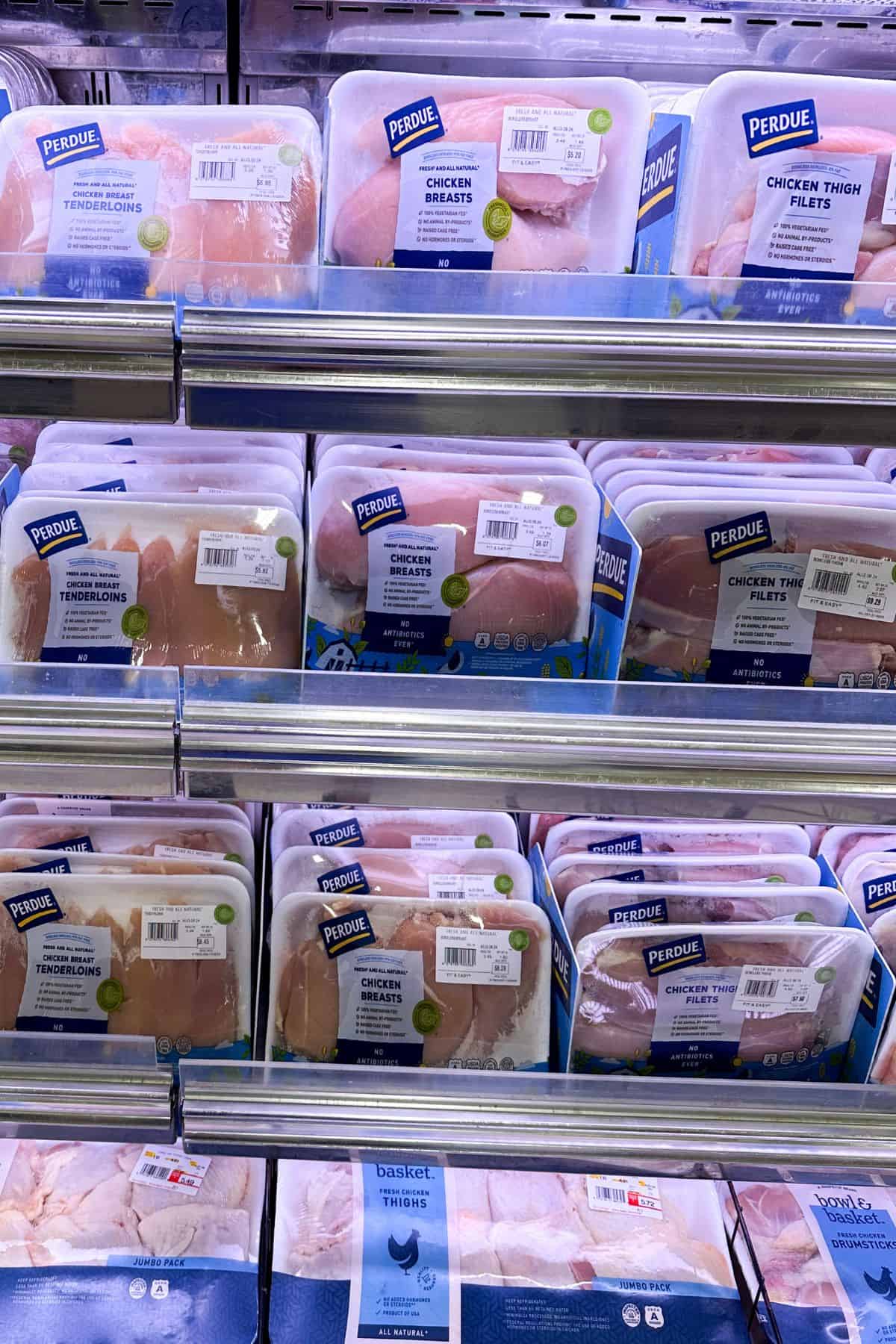 Supermarket display of chicken breast, cutlets, and tenderloins