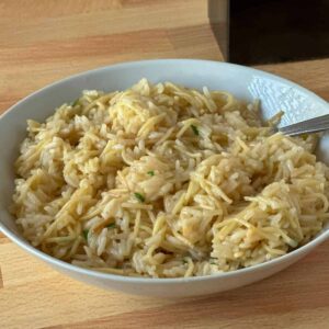 White bowl full of homemade rice pilaf