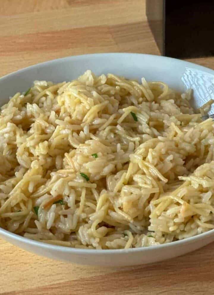 White bowl full of homemade rice pilaf