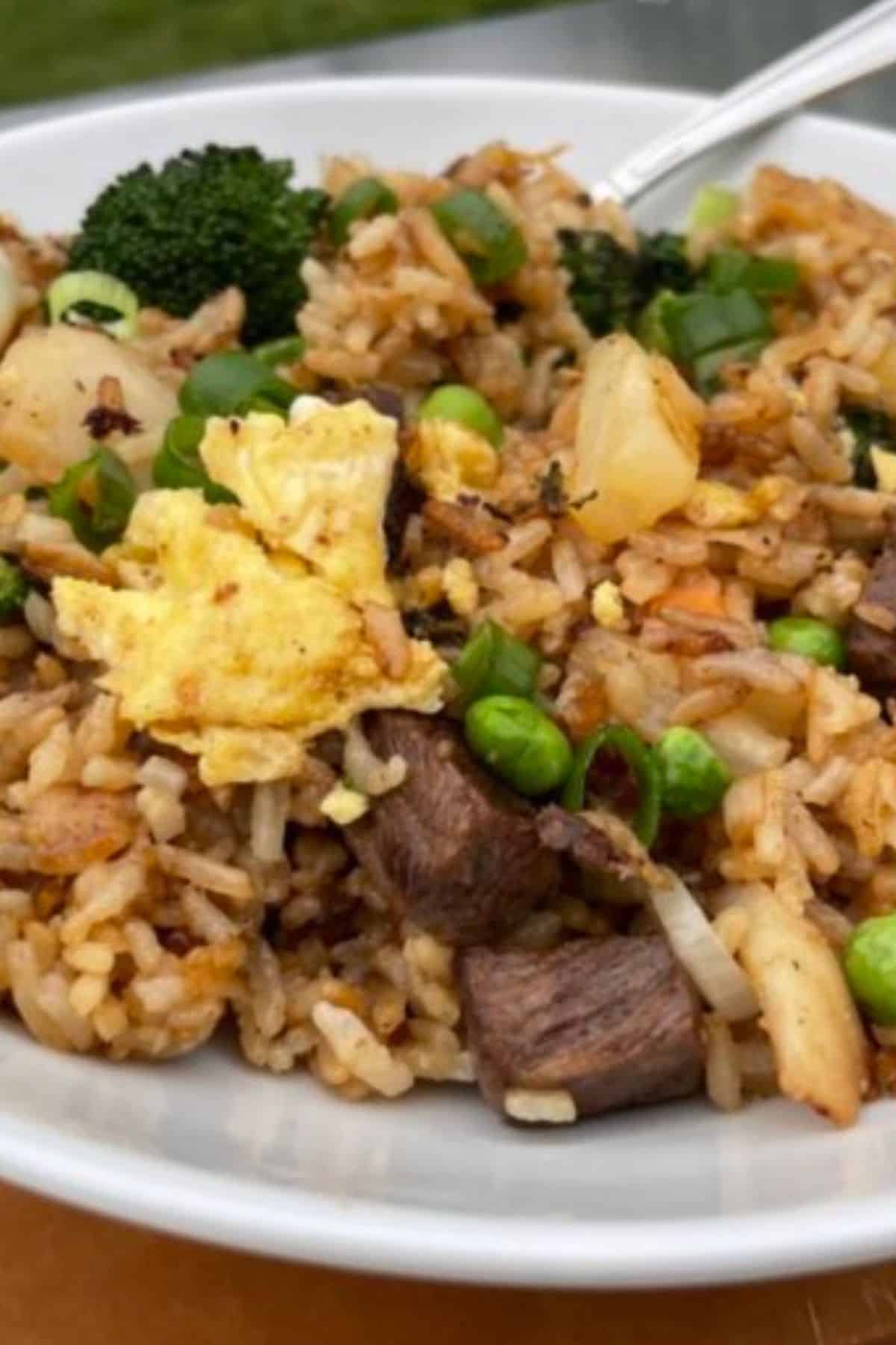 A white bowl filled with delicious homemade Blackstone fried rice.